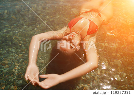 Happy woman sea relaxing floating in transparent sea water on summer holiday. Travel leisure recreation lifestyle, female in nature. Happy woman sea relaxing floating in transparent sea water on summer holiday. Travel leisure recreation lifestyle, female in nature. 119227351