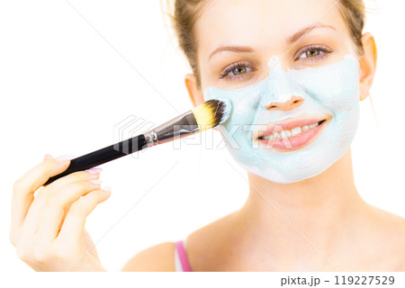 Girl apply green mud mask to face 119227529