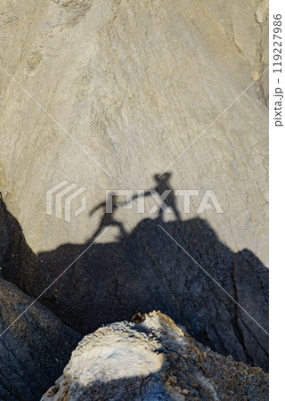 Shadow of two people on rock mountain Shadow of two people on rock mountain 119227986