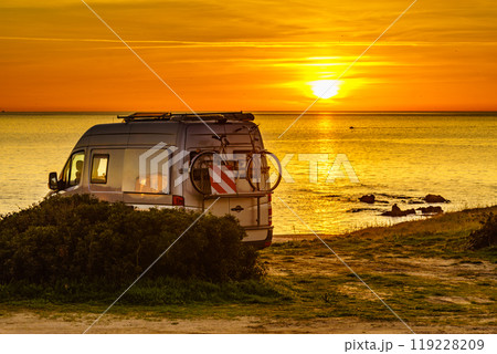 Camper with bicycles on rack camping on beach at sunrise Camper with bicycles on rack camping on beach at sunrise 119228209