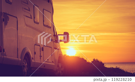 Camper vehicle on beach at sunrise Camper vehicle on beach at sunrise 119228210