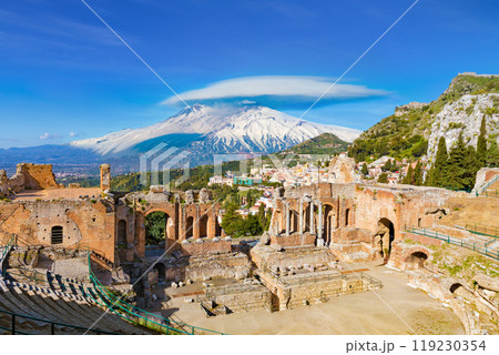 Ancient Greek theatre in Taormina on background of Etna Volcano, Italy 119230354