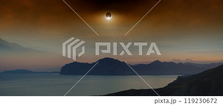 Total solar eclipse in dark red sky above sea and mountains Total solar eclipse in dark red sky above sea and mountains 119230672