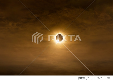 Total solar eclipse in dark red cloudy sky 119230976