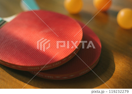 Two ping pong rackets on table 119232279