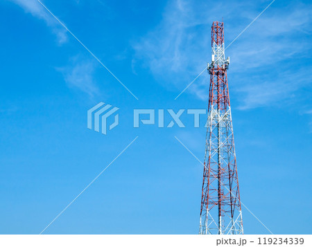 A telecommunications tower with various forms of antennas installed on its body, High antenna tower pillar of cellular communication on the blue sky background. 119234339