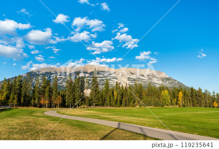 Three Sisters Sports Complex Multi-use Field & Playground. Canmore, Alberta, Canada. Canadian Rockies mountain range over the blue sky in the background. 119235641