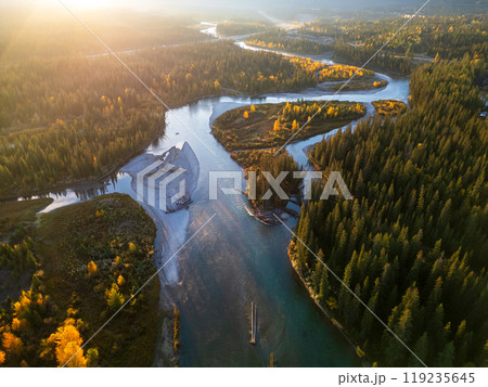 Aerial view of Canadian Rockies Bow river at dawn. Forest in yellow and green color in autumn. Canmore, Alberta, Canada. Aerial view of Canadian Rockies Bow river at dawn. Forest in yellow and green color in autumn. Canmore, Alberta, Canada. 119235645