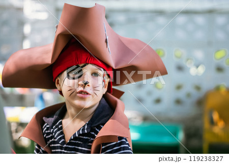 Boy Cat Pirate costume. Halloween party in kindergarten. Aqua makeup painted kids face. Bright festive Boy Cat Pirate costume. Halloween party in kindergarten. Aqua makeup painted kids face. Bright festive 119238327