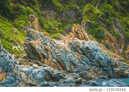 Natural background panorama edged shabby sea cliff mountain island. Gray brown stone rock texture vivid colour photo. Concept of geology, tourism after pandemic, fascination attraction power in nature Natural background panorama edged shabby sea cliff mountain island. Gray brown stone rock texture vivid colour photo. Concept of geology, tourism after pandemic, fascination attraction power in nature 119238348
