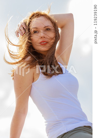 Gorgeous romantic girl outdoors. Brown long hair blowing in the wind  119239190