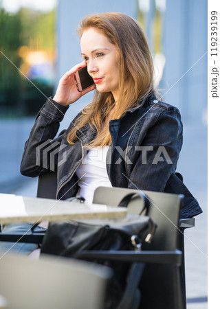 Woman wait in outdoor cafe., make phone call Woman wait in outdoor cafe., make phone call 119239199