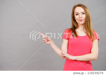Woman pointing, surprised face expression 119239274