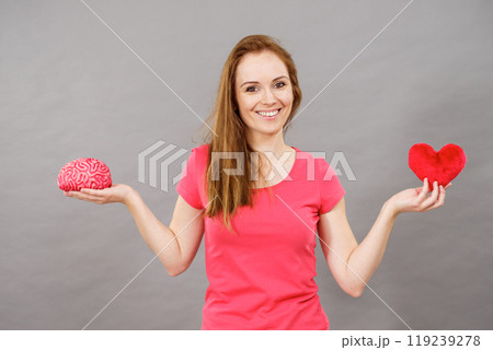 Woman holds brain and heart Woman holds brain and heart 119239278