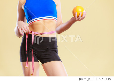 woman fit girl with measure tape and grapefruit 119239549