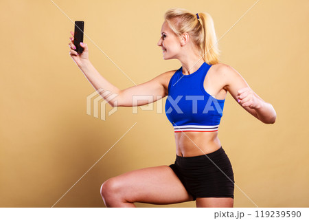 Fit woman taking selfie picture with phone 119239590