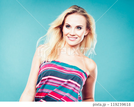 Blonde woman wearing colorful striped strapless shirt 119239618