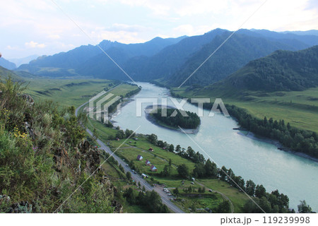 Island on river Katun, summer day. View from above of road on the river bank 119239998