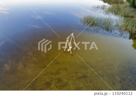 Wooden swing on White Lake. Rivne region, Ukraine. 119240112
