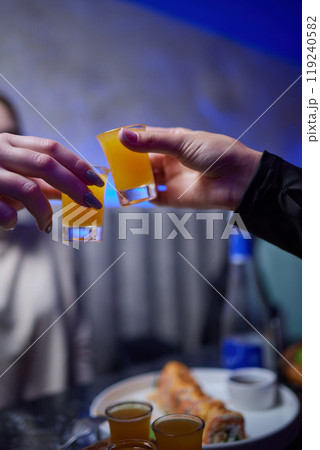 At a lively nightclub, people are enjoying wine and socializing in a chic ambiance 119240582