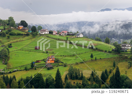 Misty morning in Vorokhta village with scenic view of Carpathian hills and fog-covered mountains 119240671