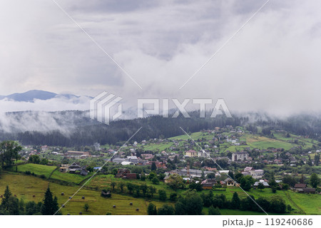 Misty morning in Vorokhta village with scenic view of Carpathian hills and fog-covered mountains 119240686