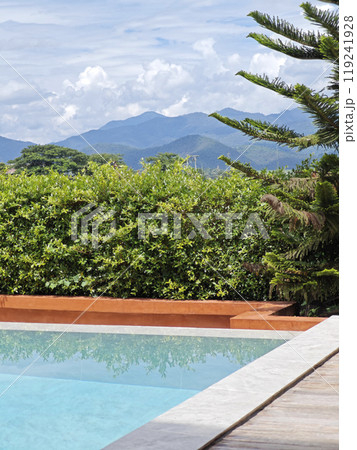 Swimming pool with sun reflecting mountain view Swimming pool with sun reflecting mountain view 119241928