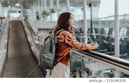 Young asian woman in international airport terminal or modern train station Young asian woman in international airport terminal or modern train station 119246330