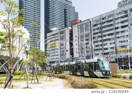 View of the circular light rail train driving past the Glory Pier in Kaohsiung, Taiwan. 119246844