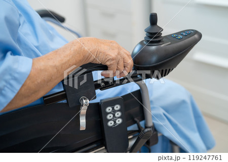 Asian senior woman patient on electric wheelchair with remote control at hospital, healthy strong medical. 119247761