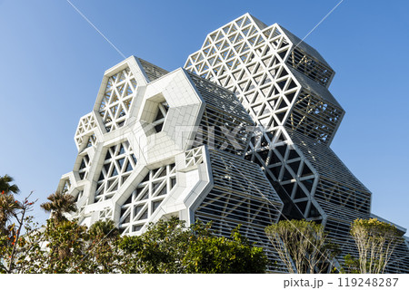 Low angle view of Kaohsiung Music Center in Taiwan. The white hexagonal building structure on the shore of Kaohsiung Port. 119248287