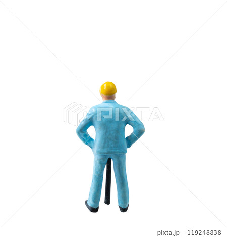 Miniature construction worker in a blue uniform isolate on white background with clipping path Miniature construction worker in a blue uniform isolate on white background with clipping path 119248838