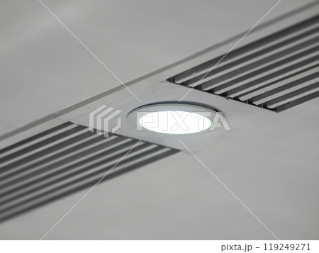 white ceiling with a poorly mounted built-in round led light in a panel with vents, white ceiling with a poorly mounted built-in round led light in a panel with vents, 119249271