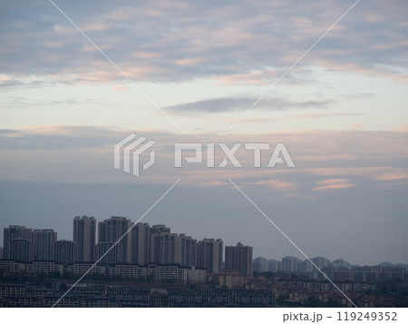 Chongqing city view in sunset, high rise buildings on hills and mountain in the background Chongqing city view in sunset, high rise buildings on hills and mountain in the background 119249352