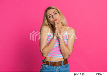 Caucasian young woman praying making wish, asking hopeful help begging apology meditation imploring Caucasian young woman praying making wish, asking hopeful help begging apology meditation imploring 119249873
