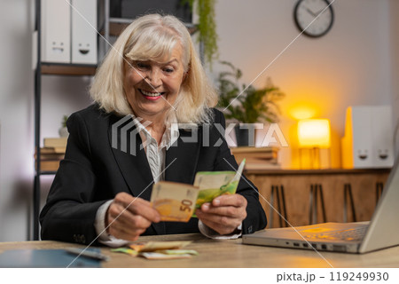 Excited senior businesswoman counting cash money dollar checking salary enjoy richness at workplace Excited senior businesswoman counting cash money dollar checking salary enjoy richness at workplace 119249930