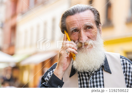 Happy man grandfather having remote conversation talk on smartphone good news gossip in city street 119250022