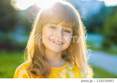 Portrait of happy preteen child girl face smiling looking at camera good mood, satisfied on park Portrait of happy preteen child girl face smiling looking at camera good mood, satisfied on park 119250061