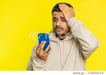 Upset sad man use smartphone play game, loses, loss fail unlucky news, bad lottery results, crisis 119250118