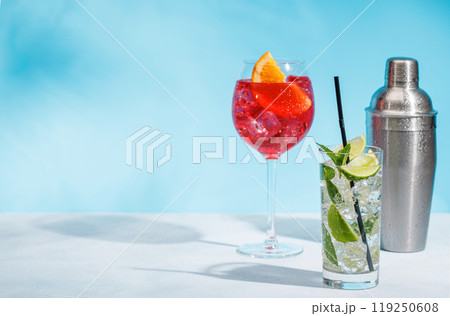 A variety of cocktails arranged on a table against a light blue background 119250608