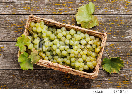 A wicker basket brimming with grapes A wicker basket brimming with grapes 119250735