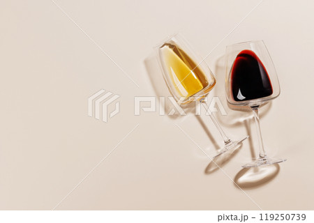 Two wine glasses arranged on a bright background Two wine glasses arranged on a bright background 119250739