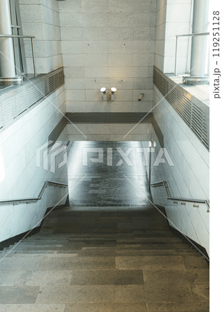 Underground descent in the metro. Deep underground descent. Steps, road crossing. Moscow metro. Vertical photo 119251128