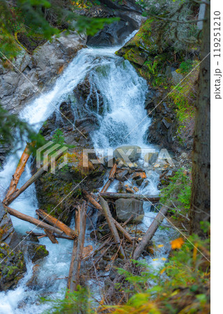 Waterfall in the Pirin Mountains in autumn. The Demyanitsa river flows in a mountain coniferous forest near the town of Bansko. Waterfall in the Pirin Mountains in autumn. The Demyanitsa river flows in a mountain coniferous forest near the town of Bansko. 119251210