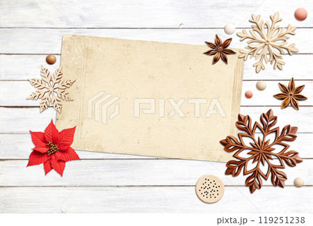 Eco friendly Christmas. Christmas background with retro wooden beads, poinsettia, star anise, snowflake on wooden boards. Copy space for text. Ecology, environmental conservation, zero waste concept 119251238