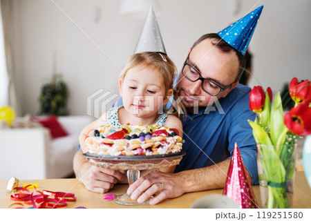 Birthday party with birthday cake for small girl. Single father and daughter celebrating together. 119251580