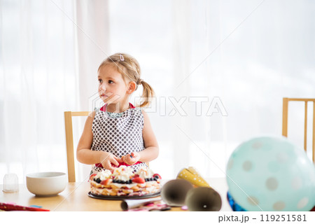 Daughter preparing and decorating cake for mom. Mothers day gift from girl. 119251581