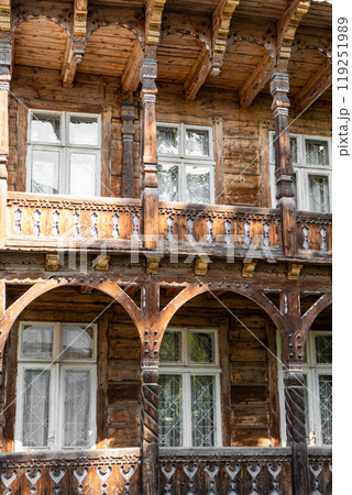 Wooden house. Windows and balcony of an old building. 119251989