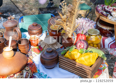 Street Ukrainian food festival. Clay dishes on the table. Street Ukrainian food festival. Clay dishes on the table. 119252059