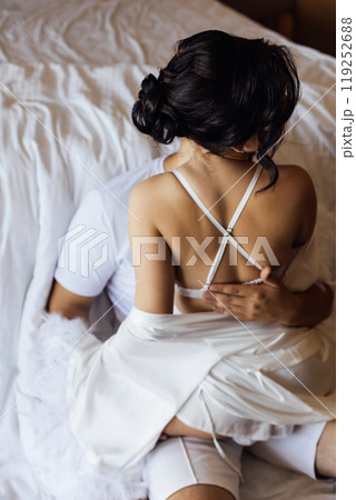 Caucasian young man and woman starting foreplay and making love on bed. Caucasian young man and woman starting foreplay and making love on bed. 119252688